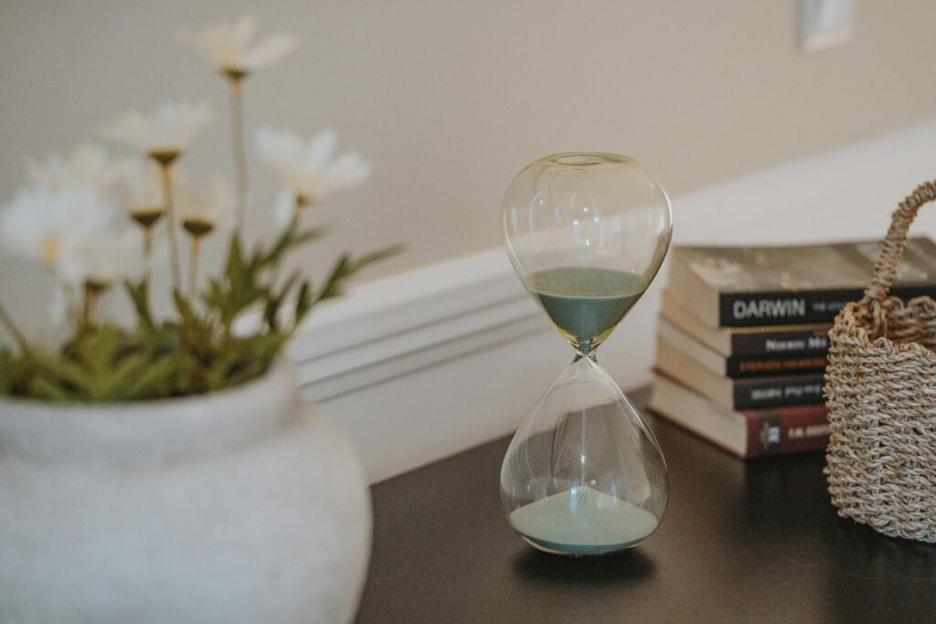 Photo of an hourglass to emphasize the point of adding slowly when creating natural rhythm within a routine.